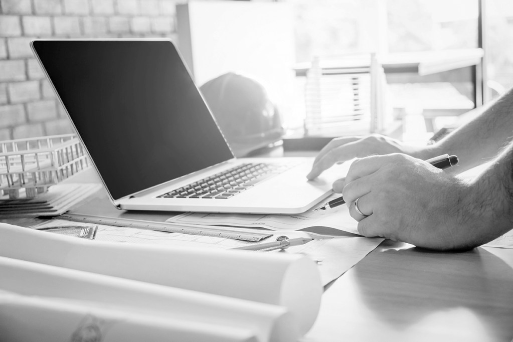 Architect or engineer working in office on blueprint. Architects